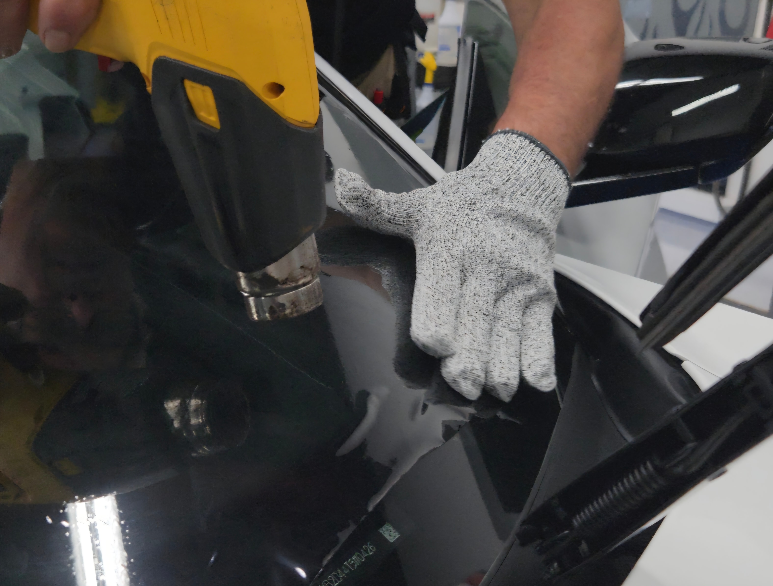 Tom's crew installing LLumar window tint at Daytona Auto Tint