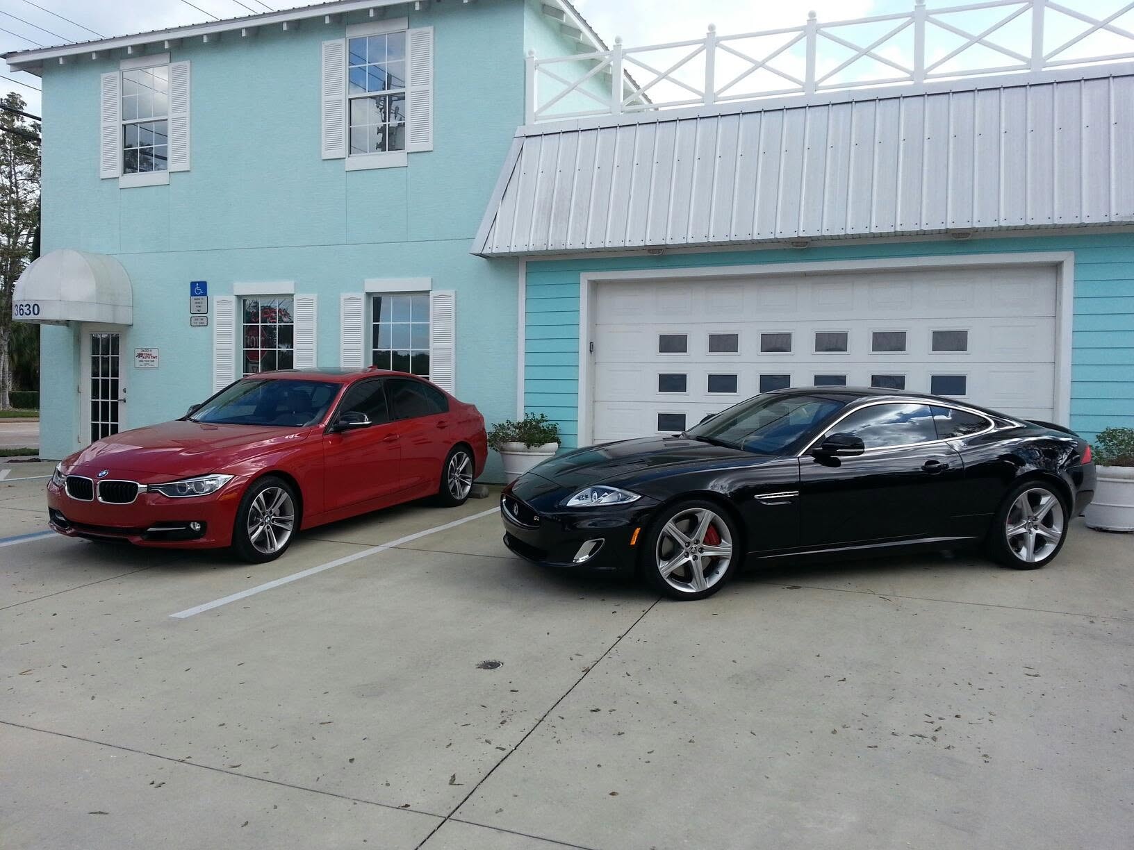 Ceramic tint on a red BMW and black Jaguar